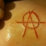 Фото знак анархии тату 24.03.2020 №014 -tattoo anarchy- tattoo-photo.ru